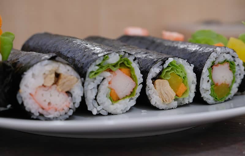 Sushi rolls served in a white plate